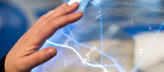 An child touching a plasma globe